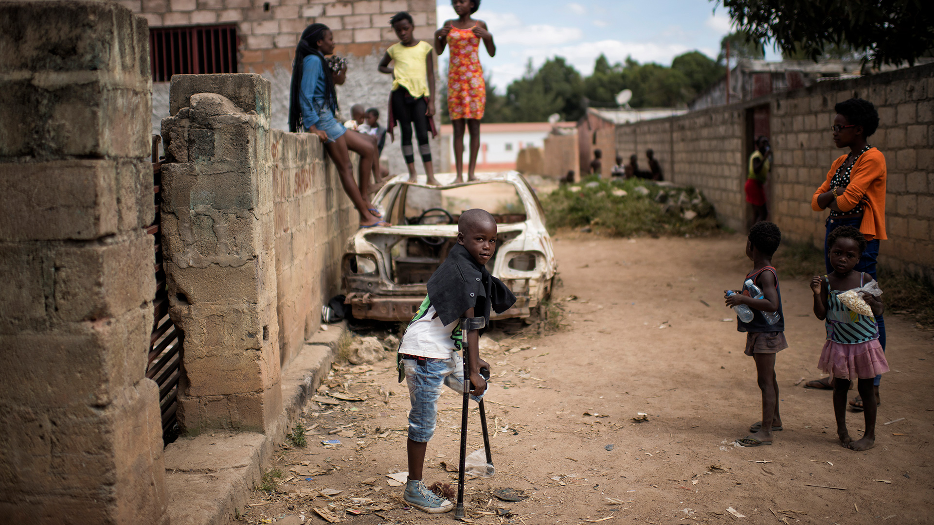 Eight year-old Manuel stands outside the yard in his family's home in Huambo, Angola. He is the youngest of a group of boys who were seriously wounded while playing with a mortar round in December 2016.