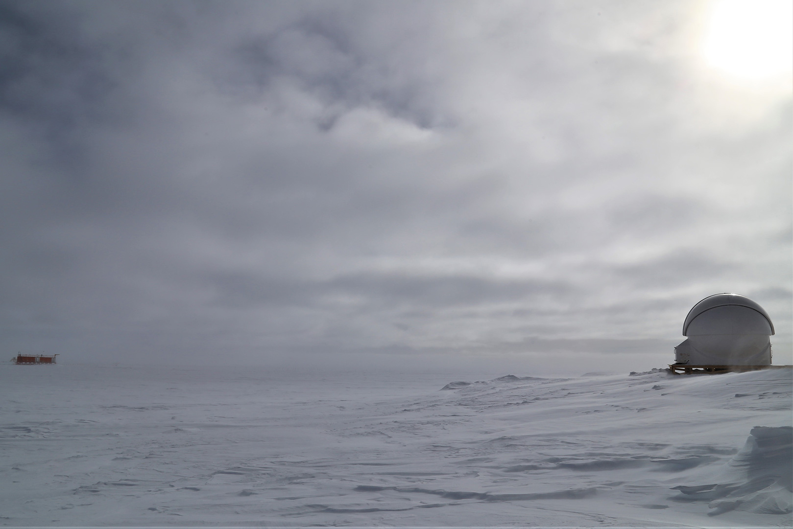 Antarctica: as remote as it gets on Earth. Concordia research station is a collaboration between the French Polar Institute and the Italian Antarctic programme. It is one of only three bases inhabited all year long and is located at the mountain plateau called Dome C. Pictured in this image is the astronomical observatory near the base.