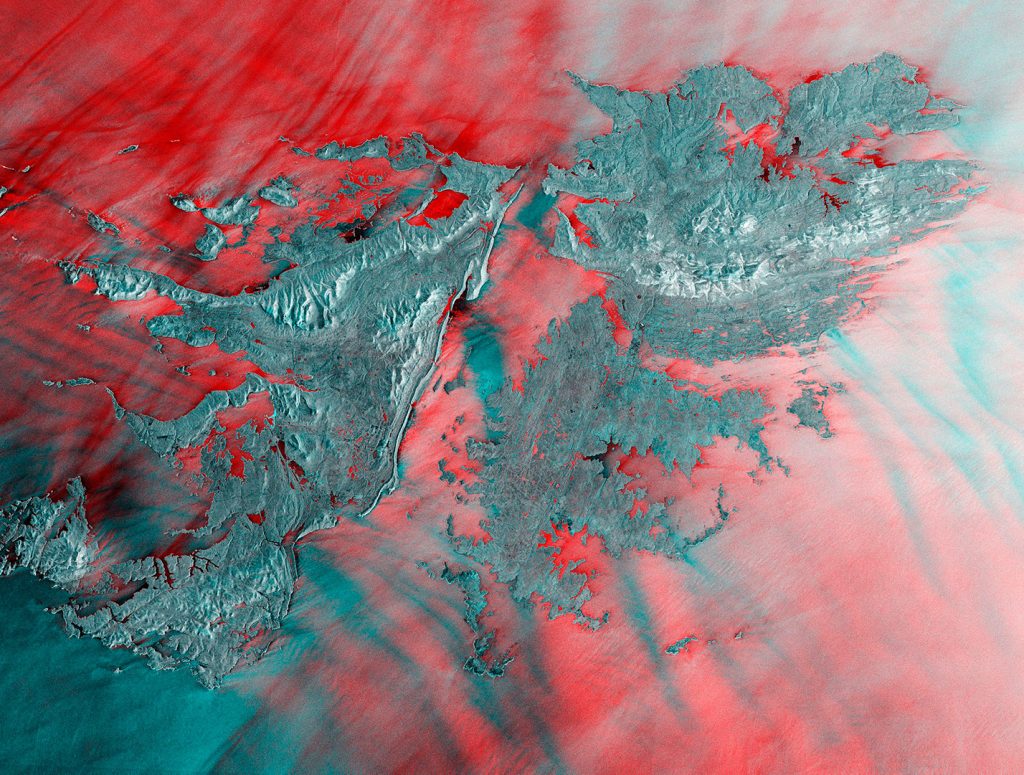 The Falkland Islands are featured in this radar image captured by the Copernicus Sentinel-1 mission, coordinated and managed by the European Commission. This multi-temporal image combines two radar acquisitions taken one month apart to show changes over time. The first image was captured on 29 December 2019, while the second was taken on 22 January 2020. Here, the main changes between acquisitions occurred in the open ocean, with the bright red colours showing wavy waters in December 2019. The Copernicus Sentinel-1 mission provides a continuous sampling of the seas, offering information on wind and waves. This is useful for understanding interactions between waves and currents and to improve efficiency for shipping and wave-energy applications.