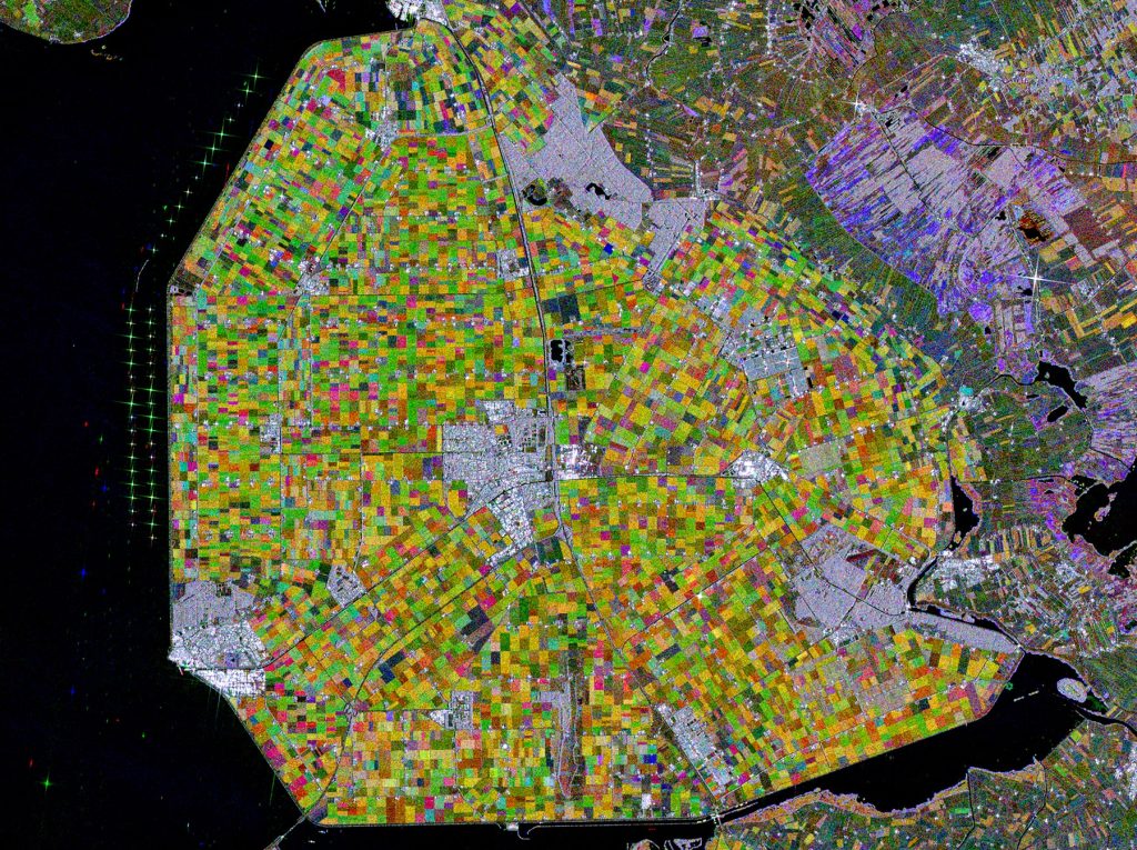 This image captured by the Copernicus Sentinel-1 mission shows us part of the Dutch province of Flevoland where there is of the Netherlands’ largest wind farms. The strong, almost star-shaped, reflections that can be seen near the shore represent around 86 wind turbines. The wind farm is said to generate approximately 1.4 billion kWh of clean renewable energy per year – comparable to the power consumption of over 400,000 households. Satellite data can be used to improve the efficiency and sustainability of marine renewable energy by assessing wind resources and monitoring protected windfarm territories.