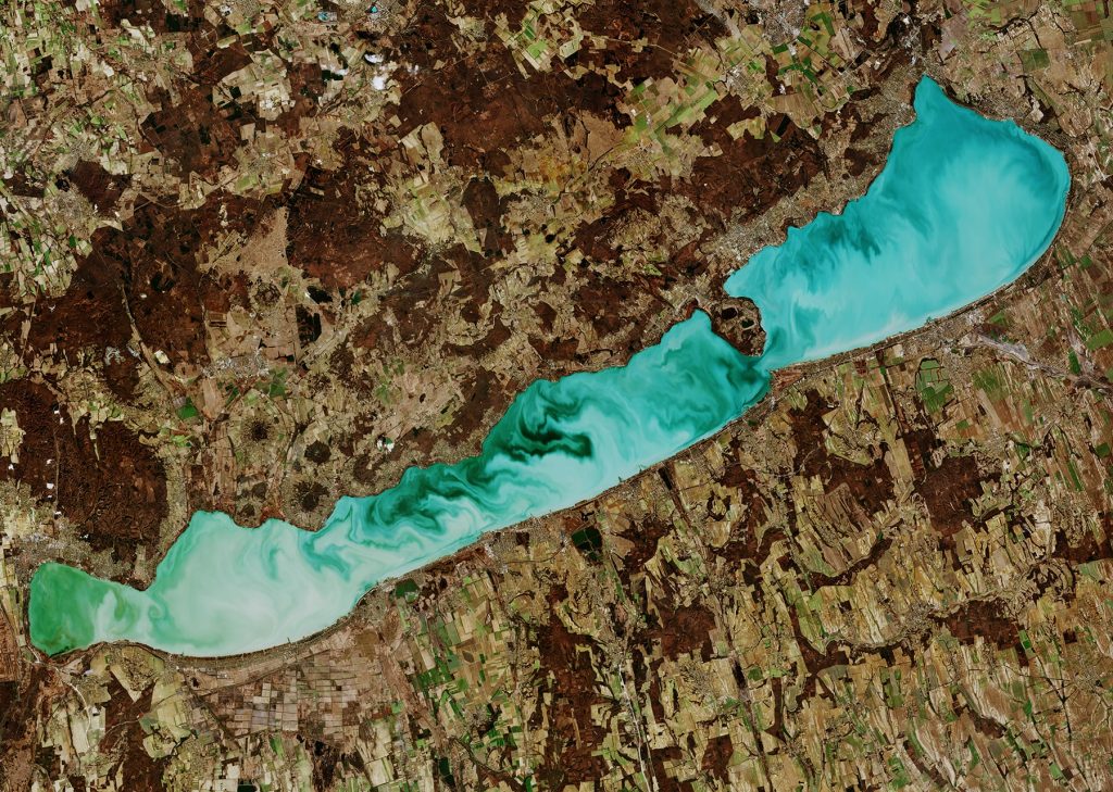 This image, captured on 27 February 2019, shows Lake Balaton in western Hungary, the largest fresh water lake in Central Europe. In this image Lake Balaton’s striking emerald-green colour is most likely due to its shallow waters and chemical composition. It is heavy in carbonates and sulphates, and there are also around 2000 species of algae that grow in its waters.